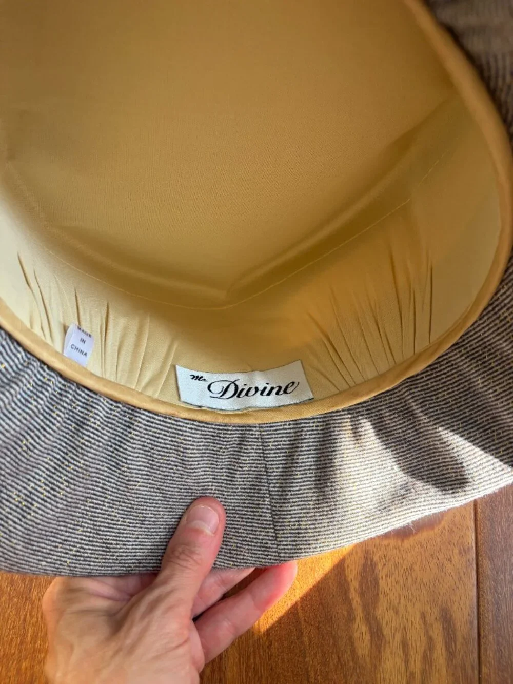 Ms. Divine vintage wool cloche hat with gold flecks while featuring a prominent